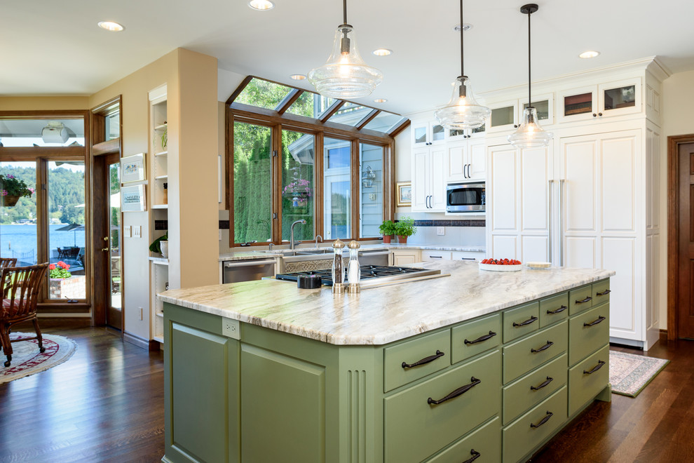 Design ideas for a large traditional u-shaped eat-in kitchen in Seattle with a farmhouse sink, flat-panel cabinets, white cabinets, quartzite benchtops, beige splashback, porcelain splashback, stainless steel appliances, dark hardwood floors and with island.