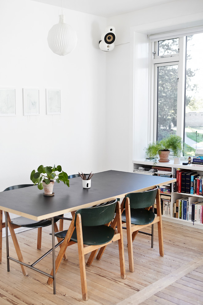 This is an example of a scandinavian dining room in Wiltshire.