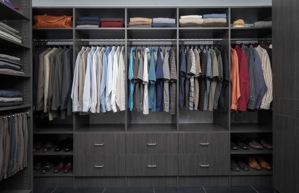 This is an example of a mid-sized contemporary men's walk-in wardrobe in Phoenix with flat-panel cabinets, grey cabinets and porcelain floors.