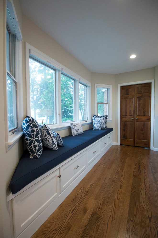 Example of a huge transitional medium tone wood floor open concept kitchen design with an undermount sink, shaker cabinets, white cabinets, marble countertops, white backsplash, ceramic backsplash, stainless steel appliances and two islands