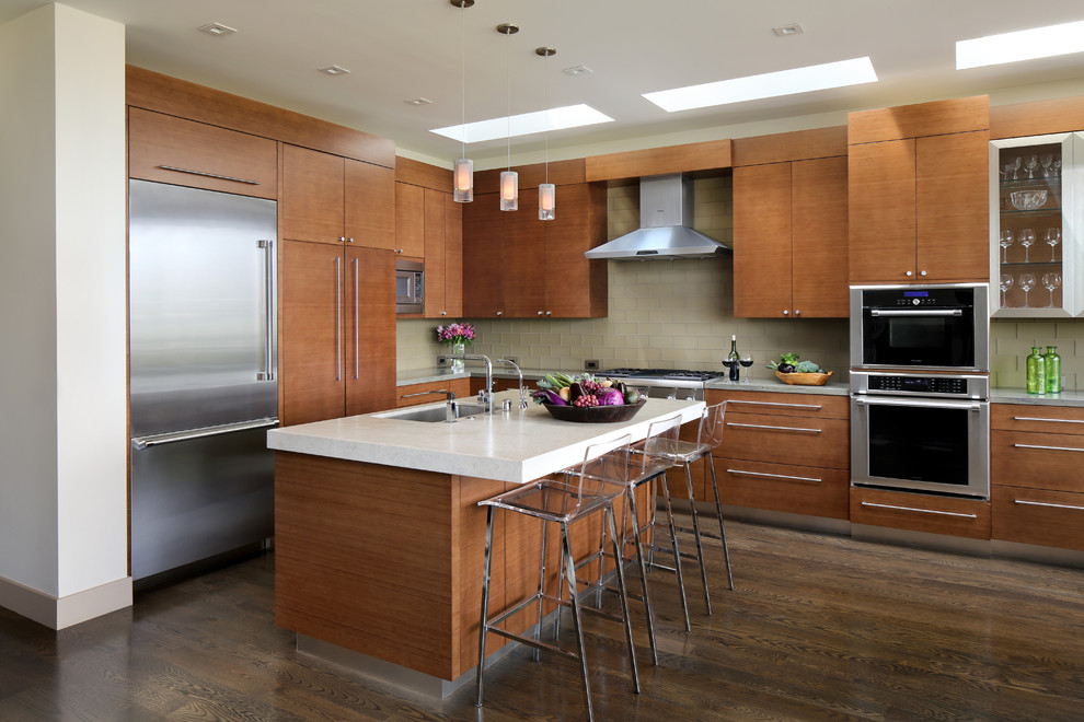 Trendy l-shaped dark wood floor kitchen photo in San Francisco with an undermount sink, flat-panel cabinets, medium tone wood cabinets, beige backsplash, glass tile backsplash, stainless steel appliances and an island
