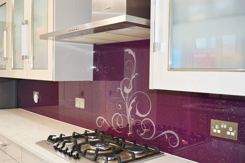 This is an example of a large modern eat-in kitchen in Hertfordshire with flat-panel cabinets, white cabinets, granite benchtops, glass sheet splashback and no island.