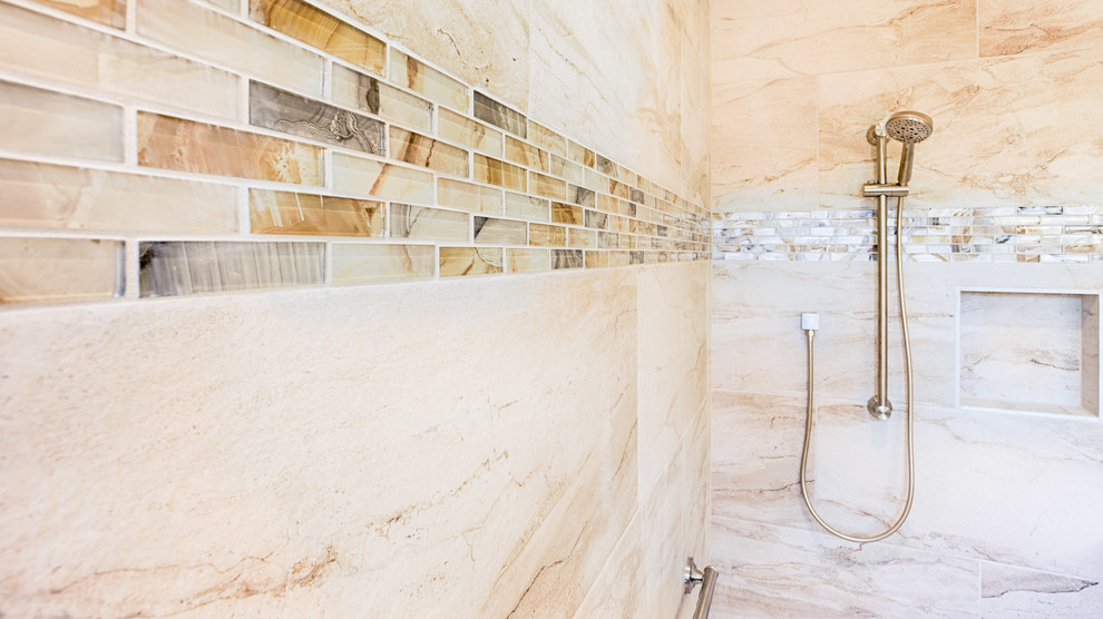 Example of a large transitional master gray tile and porcelain tile doorless shower design in Phoenix with recessed-panel cabinets, medium tone wood cabinets, beige walls, an undermount sink and quartzite countertops