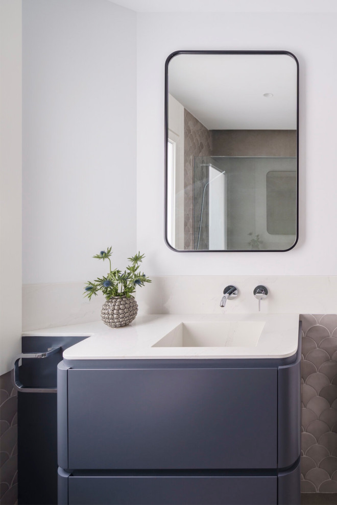 Mid-sized contemporary 3/4 bathroom in Other with gray tile, ceramic tile, white walls, ceramic floors, an integrated sink, engineered quartz benchtops, grey floor, white benchtops, a single vanity, a built-in vanity, flat-panel cabinets, grey cabinets, a curbless shower and a hinged shower door.