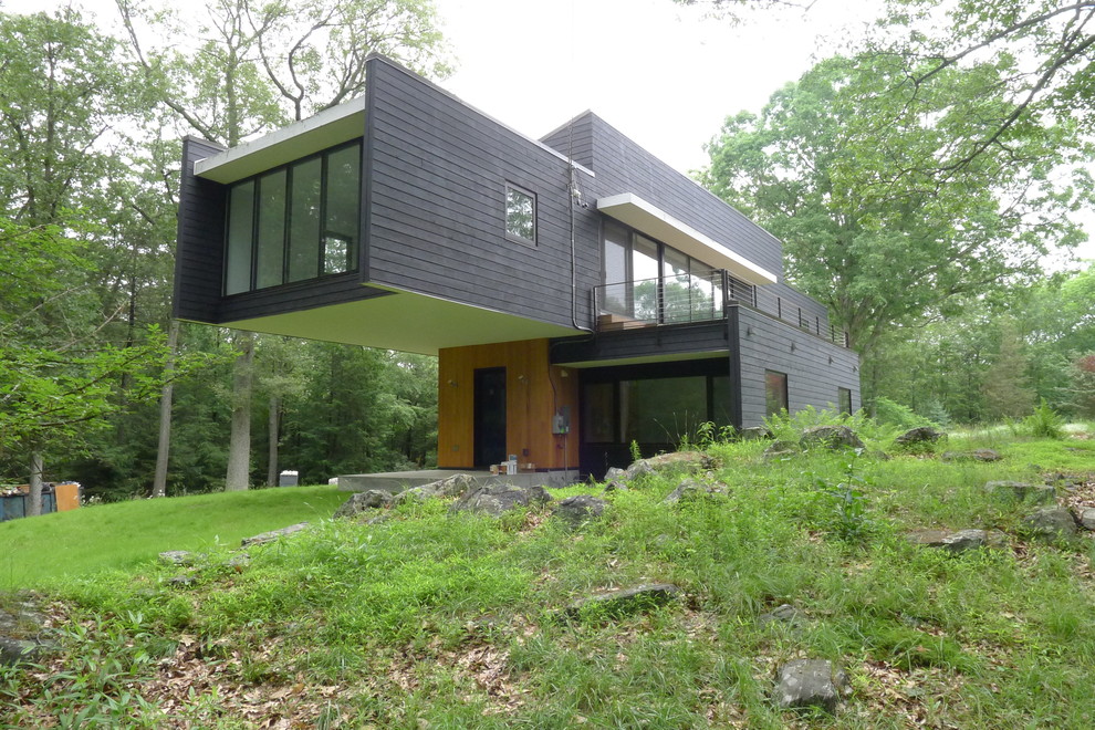 Photo of a mid-sized contemporary two-storey exterior in New York with wood siding.