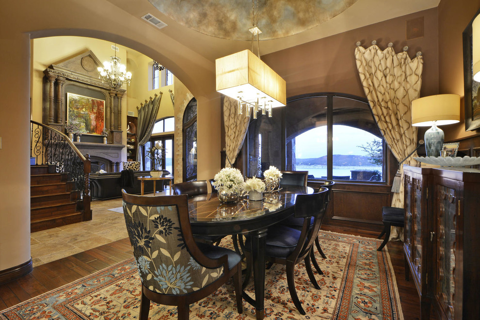 Photo of a mediterranean separate dining room in Austin with brown walls and dark hardwood floors.