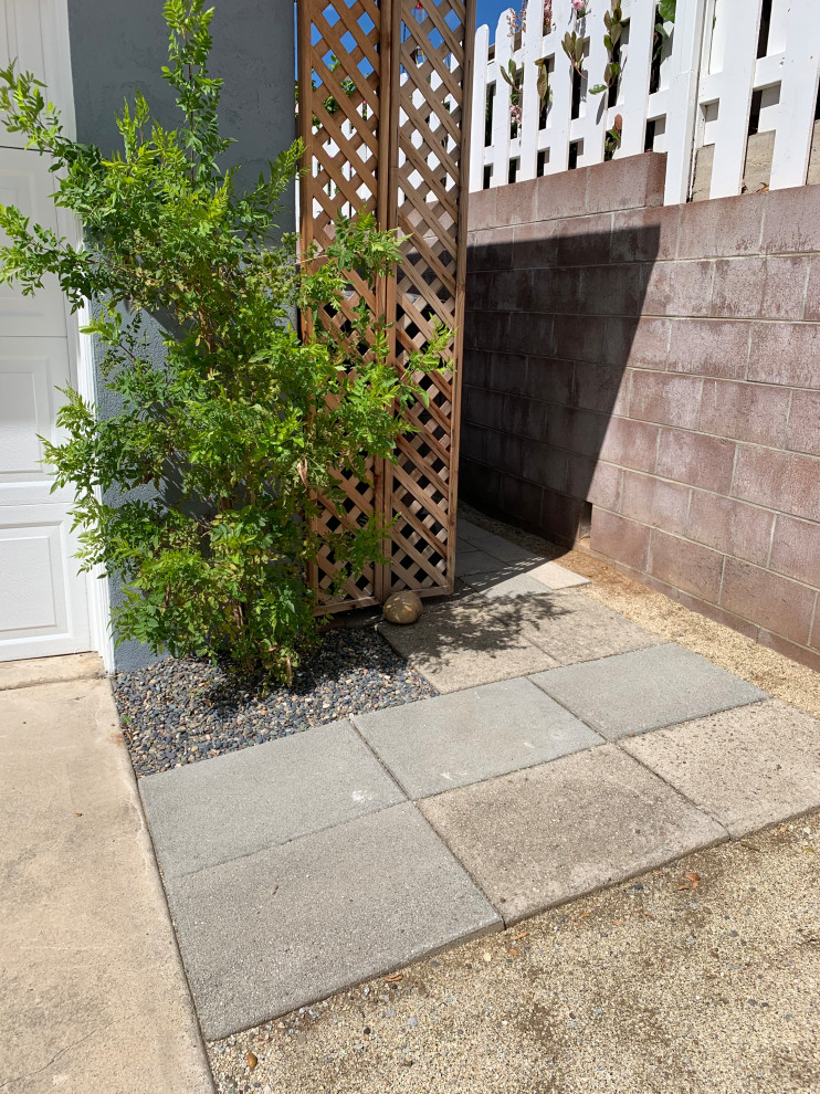 This is an example of a small beach style front yard full sun xeriscape in San Diego with with path and concrete pavers.
