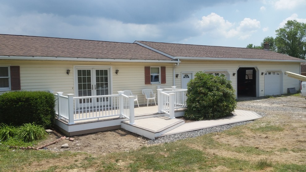 Inspiration for a mid-sized side yard deck remodel with no cover