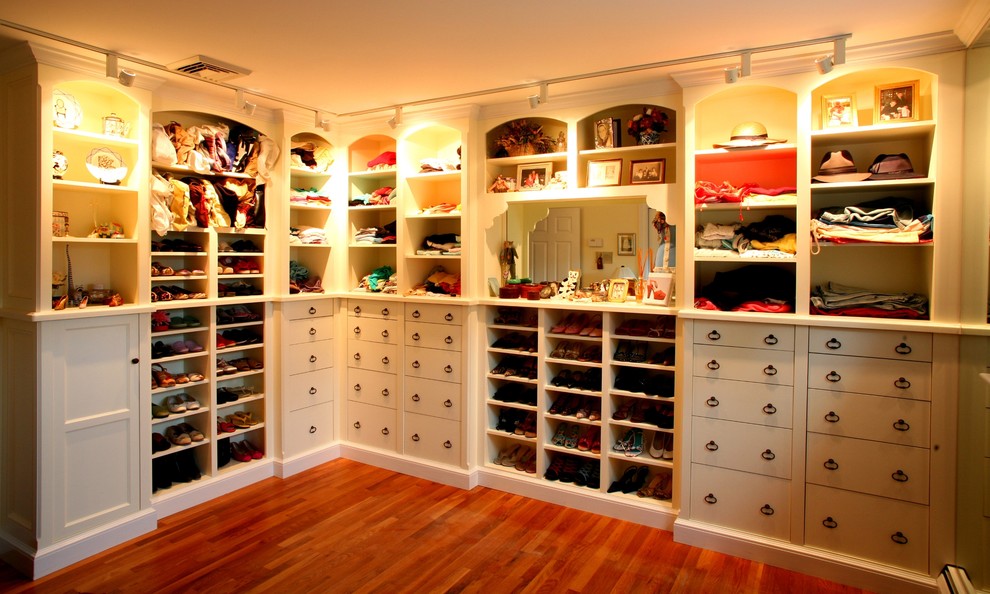 Traditional walk-in wardrobe in Boston with white cabinets.