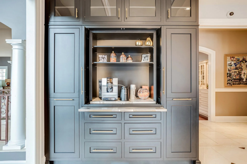 Inspiration for a transitional beige floor kitchen remodel in Baltimore with black cabinets, beige backsplash, an island and beige countertops