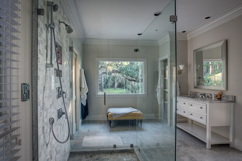 Photo of a mid-sized beach style master bathroom in Atlanta with white cabinets, an open shower, an undermount sink, granite benchtops, grey floor, an open shower, recessed-panel cabinets, grey walls, porcelain floors and grey benchtops.