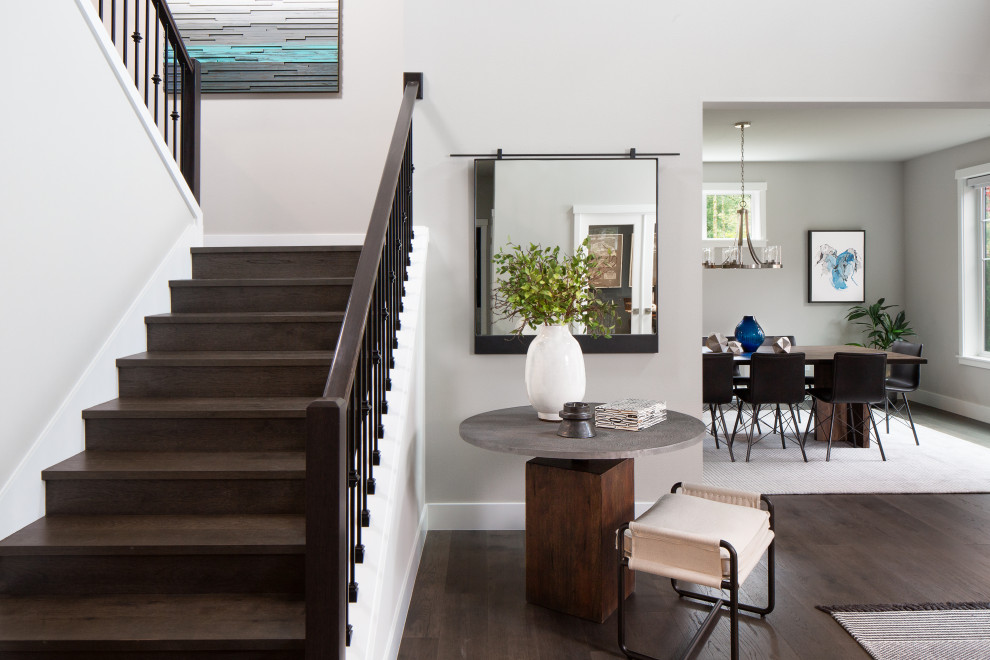 Mid-sized modern wood u-shaped staircase in Seattle with wood risers and metal railing.