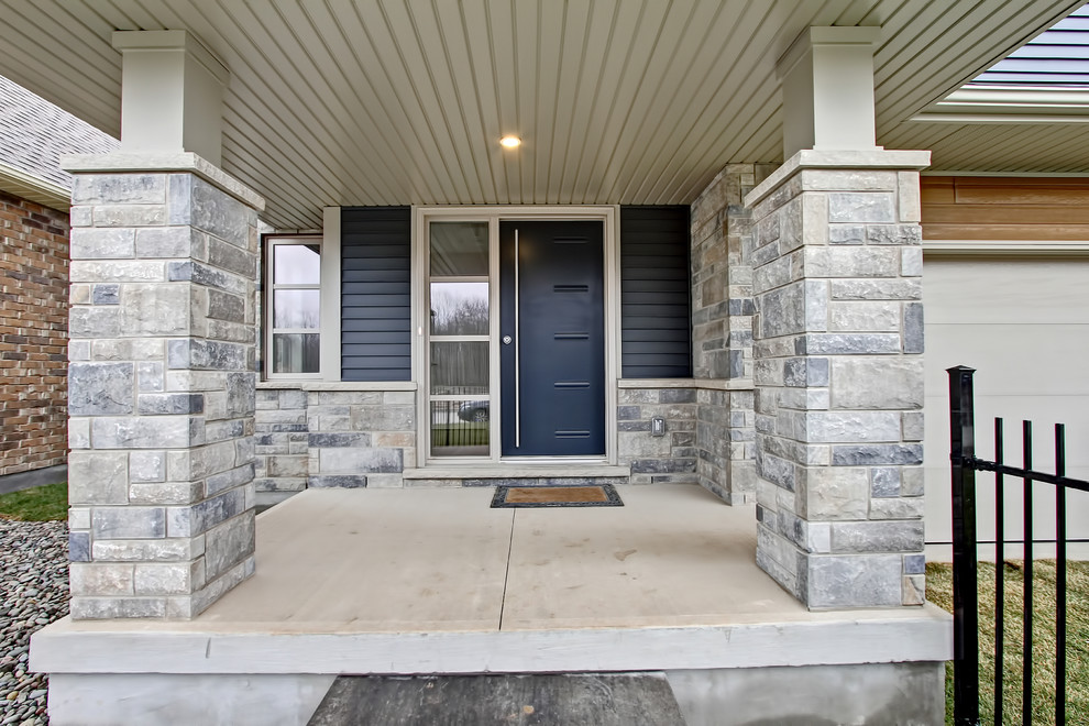 Inspiration for a mid-sized transitional blue two-story mixed siding flat roof remodel in Toronto