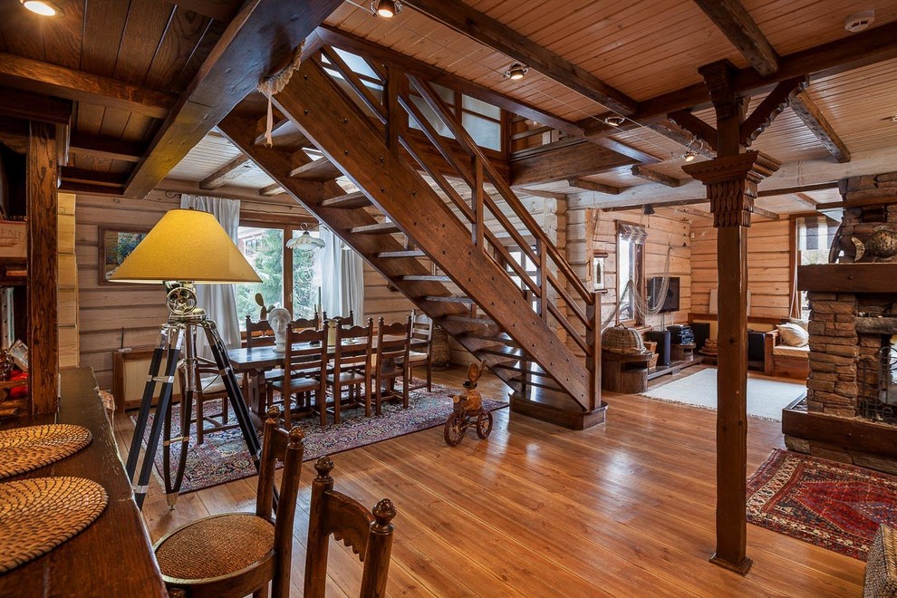 Photo of a large country wood straight staircase in Other with wood risers.