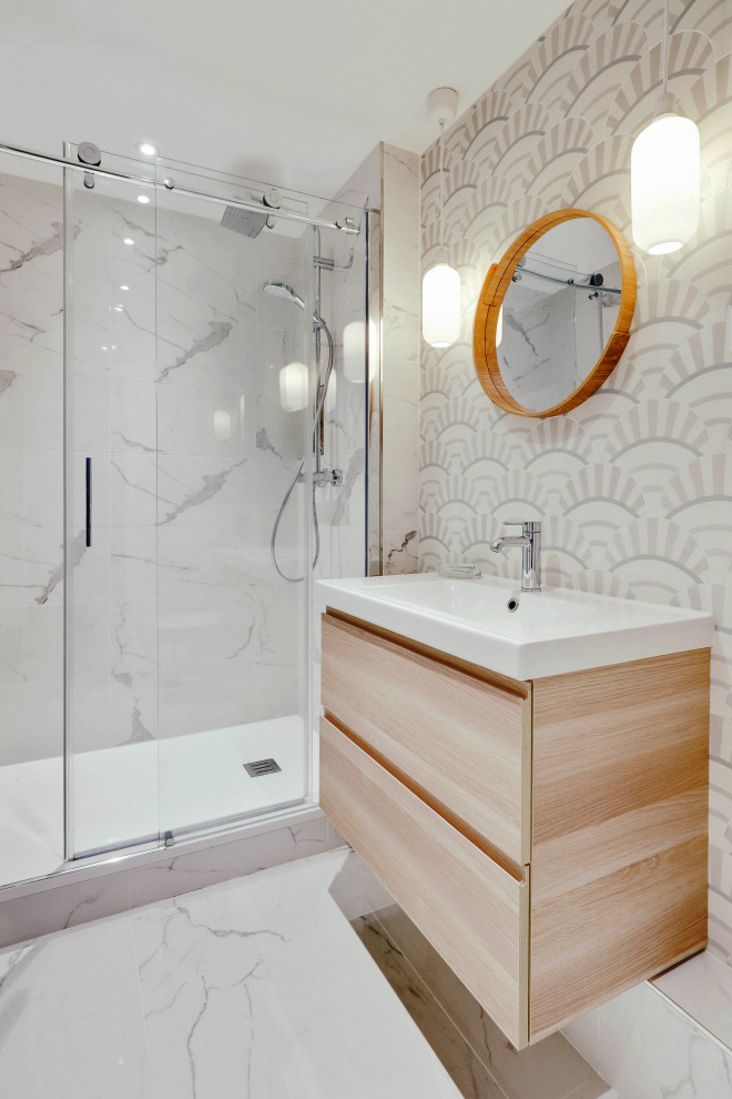 This is an example of a mid-sized contemporary master bathroom in Paris with beaded inset cabinets, beige cabinets, a curbless shower, a wall-mount toilet, multi-coloured tile, cement tile, white walls, ceramic floors, a console sink, white floor, a sliding shower screen and white benchtops.