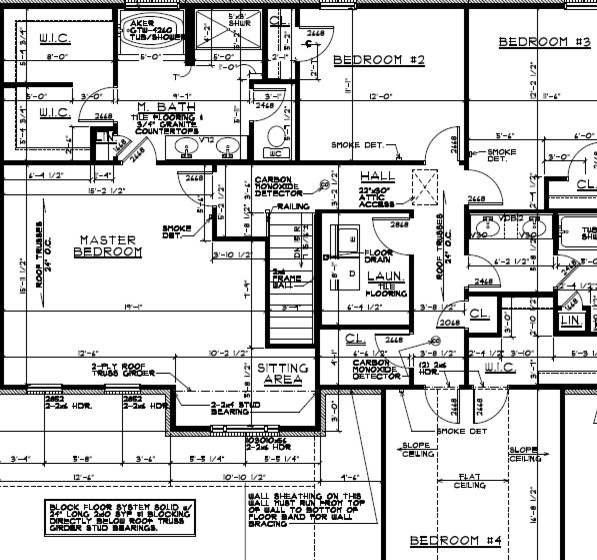 How should hardwood in an Lshaped hall be installed?