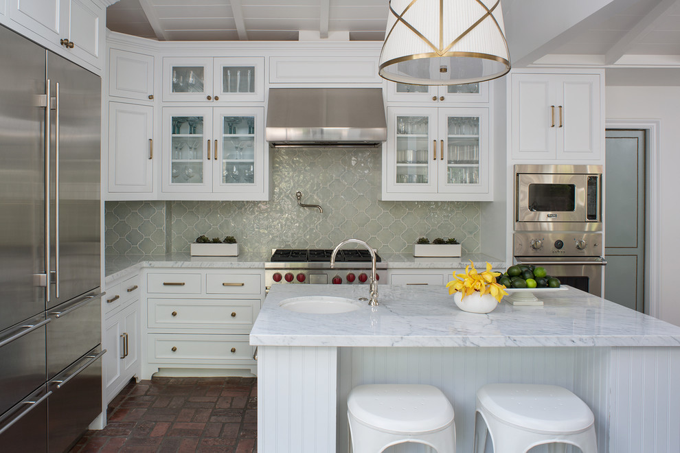 Large traditional l-shaped separate kitchen in Los Angeles with a drop-in sink, beaded inset cabinets, white cabinets, marble benchtops, green splashback, ceramic splashback, stainless steel appliances, brick floors, with island, red floor and white benchtop.