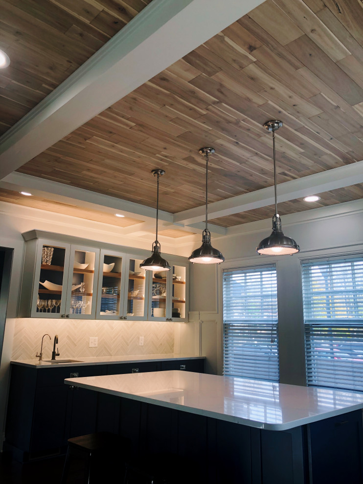 Inspiration for a large traditional u-shaped kitchen/diner in Indianapolis with a belfast sink, shaker cabinets, blue cabinets, quartz worktops, grey splashback, ceramic splashback, stainless steel appliances, dark hardwood flooring, an island, brown floors, white worktops and a timber clad ceiling.