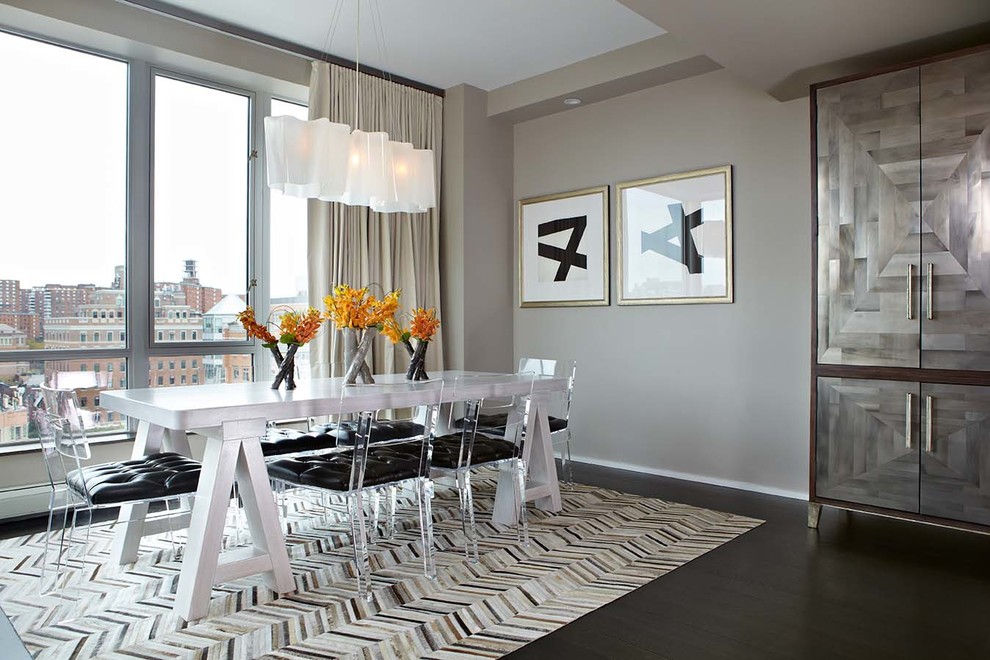 Large contemporary dining room in New York with grey walls, dark hardwood floors, no fireplace and grey floor.
