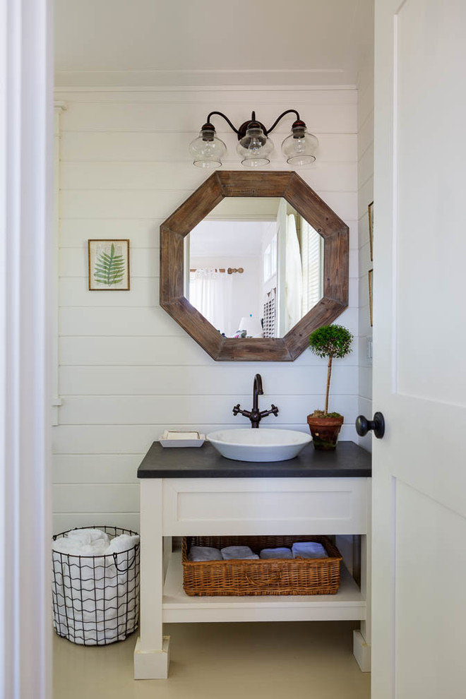 Example of a mid-sized beach style 3/4 bathroom design in Boston with white cabinets, a one-piece toilet, white walls, a vessel sink and soapstone countertops
