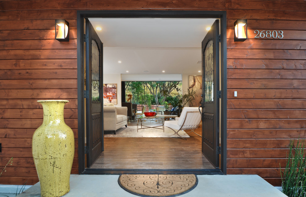 Mid-sized contemporary front door in Orange County with a double front door and a dark wood front door.