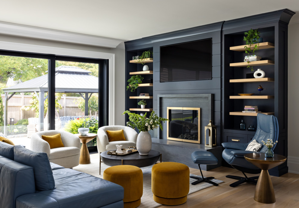 Inspiration for a mid-sized transitional light wood floor and beige floor living room remodel in New York with gray walls, a standard fireplace, a stone fireplace and a media wall