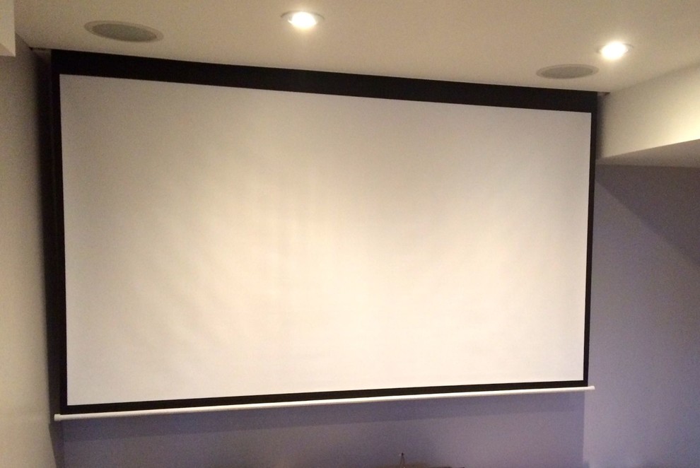 This is an example of a small modern enclosed home theatre in Toronto with purple walls, ceramic floors and a projector screen.