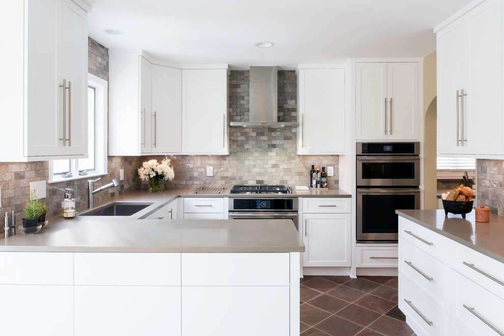 Example of a mid-sized transitional u-shaped multicolored floor and slate floor kitchen design in DC Metro with an undermount sink, shaker cabinets, white cabinets, multicolored backsplash, stainless steel appliances, a peninsula, quartz countertops and marble backsplash