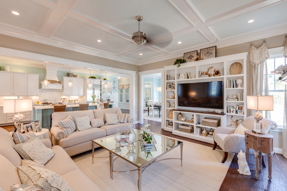 Example of a large beach style open concept medium tone wood floor living room design with brown walls, a media wall, a standard fireplace and a stone fireplace