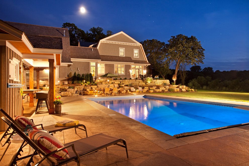 Design ideas for a beach style rectangular pool in Minneapolis with a pool house.