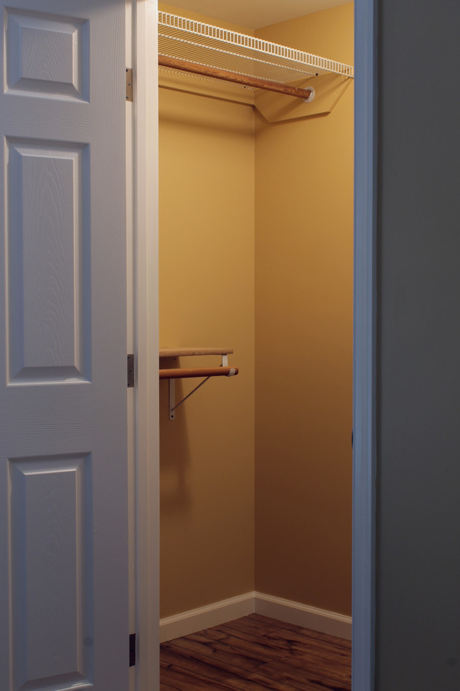 Photo of a small contemporary gender-neutral walk-in wardrobe in Philadelphia with laminate floors.