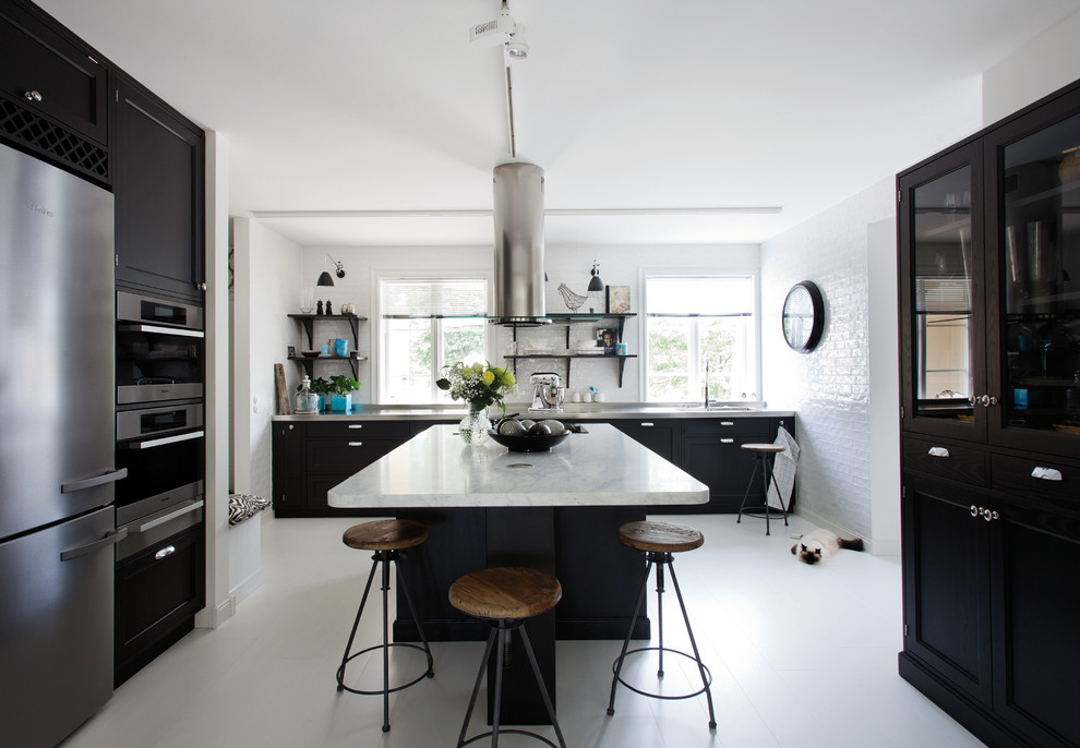 Photo of a large scandinavian single-wall eat-in kitchen in Stockholm with shaker cabinets, white splashback, stainless steel appliances, painted wood floors, with island and marble benchtops.