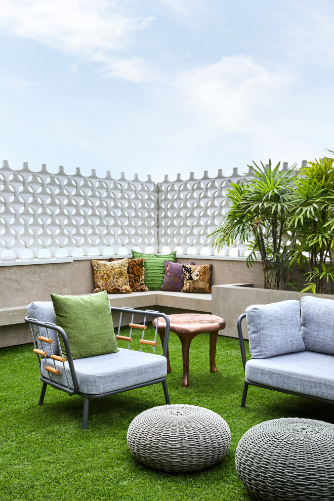 This is an example of a contemporary rooftop deck in Mumbai with no cover and mixed railing.