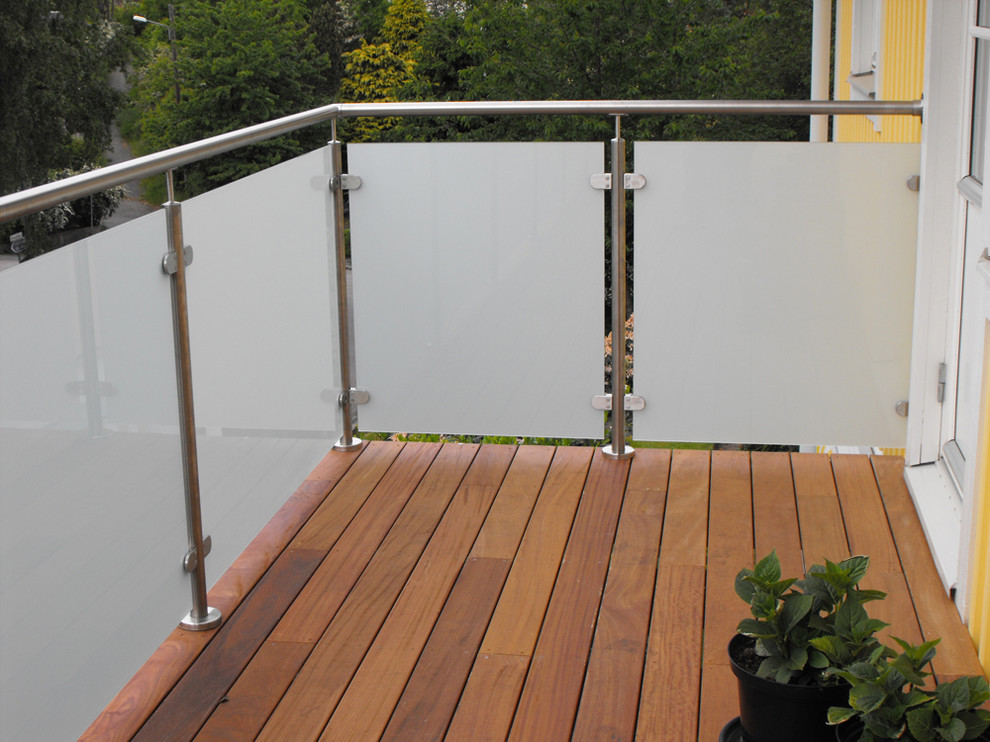 This is an example of a small transitional balcony in Moscow with an awning and glass railing.