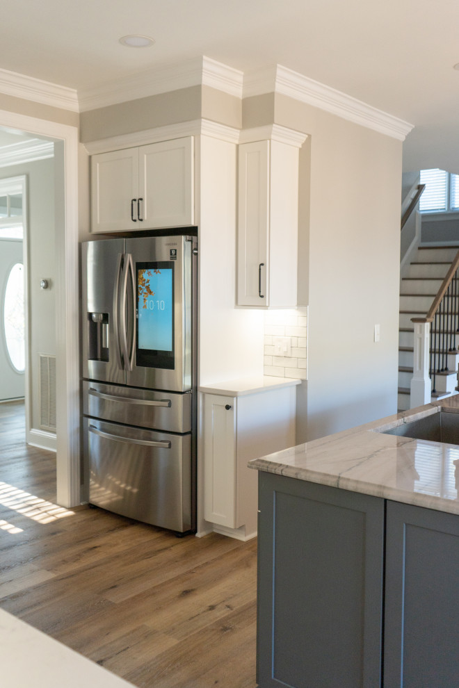 Inspiration for a contemporary u-shaped eat-in kitchen in Raleigh with wood benchtops, white splashback, ceramic splashback, stainless steel appliances, with island, beige floor and blue benchtop.