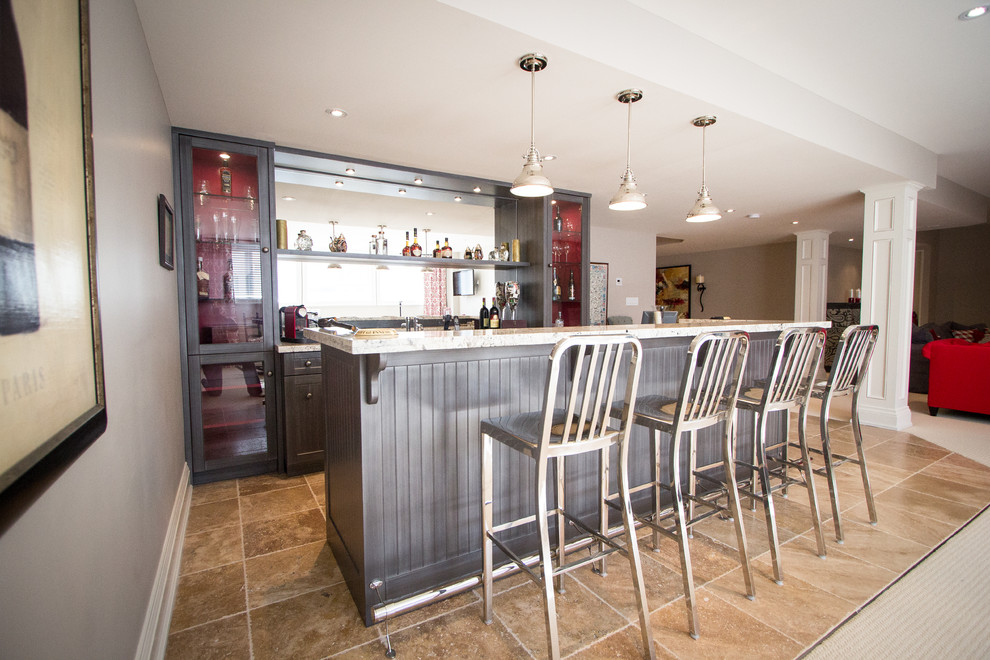 Photo of an arts and crafts galley wet bar in Toronto with an undermount sink, shaker cabinets, brown cabinets, granite benchtops, mirror splashback and travertine floors.