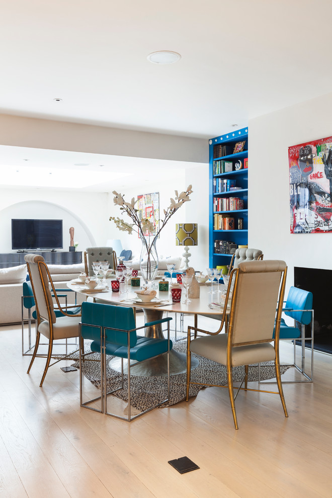 Photo of a large eclectic dining room in London with grey walls and light hardwood floors.