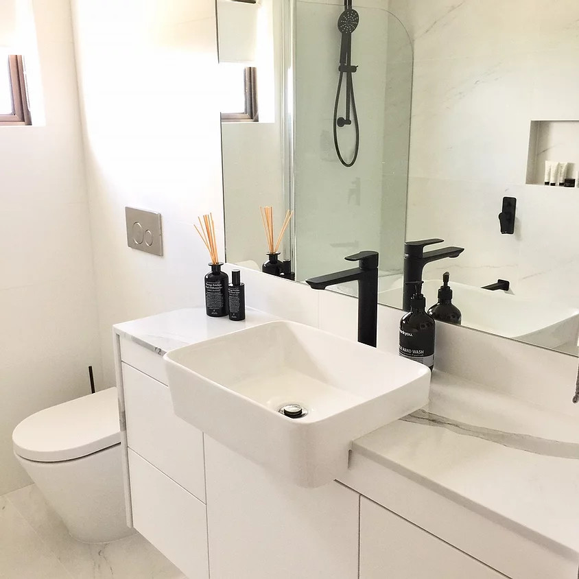Design ideas for a small scandinavian master bathroom in Gold Coast - Tweed with furniture-like cabinets, white cabinets, an alcove shower, a wall-mount toilet, white tile, porcelain tile, white walls, an integrated sink, engineered quartz benchtops, white floor, a hinged shower door, white benchtops, an enclosed toilet, a single vanity and a floating vanity.