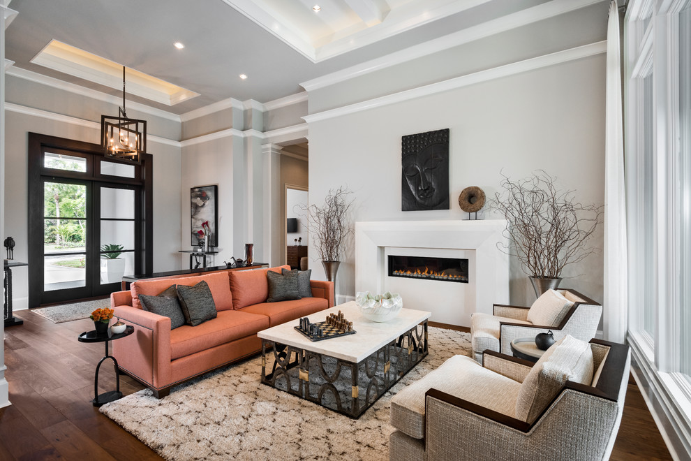 This is an example of a mid-sized contemporary open concept living room in Miami with grey walls, a plaster fireplace surround, brown floor, dark hardwood floors and a ribbon fireplace.