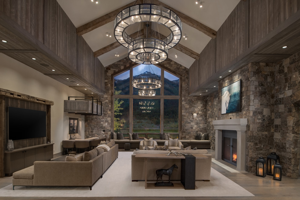 Country open concept living room in Other with dark hardwood floors, a standard fireplace, a wall-mounted tv and brown floor.