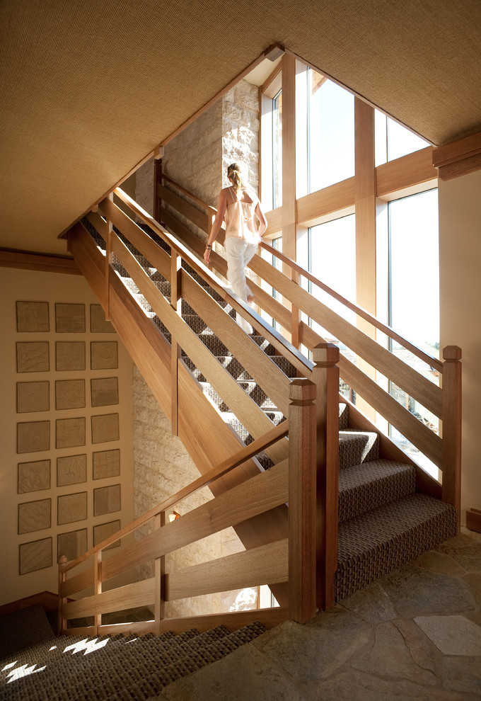 Transitional carpeted staircase in Los Angeles with carpet risers.