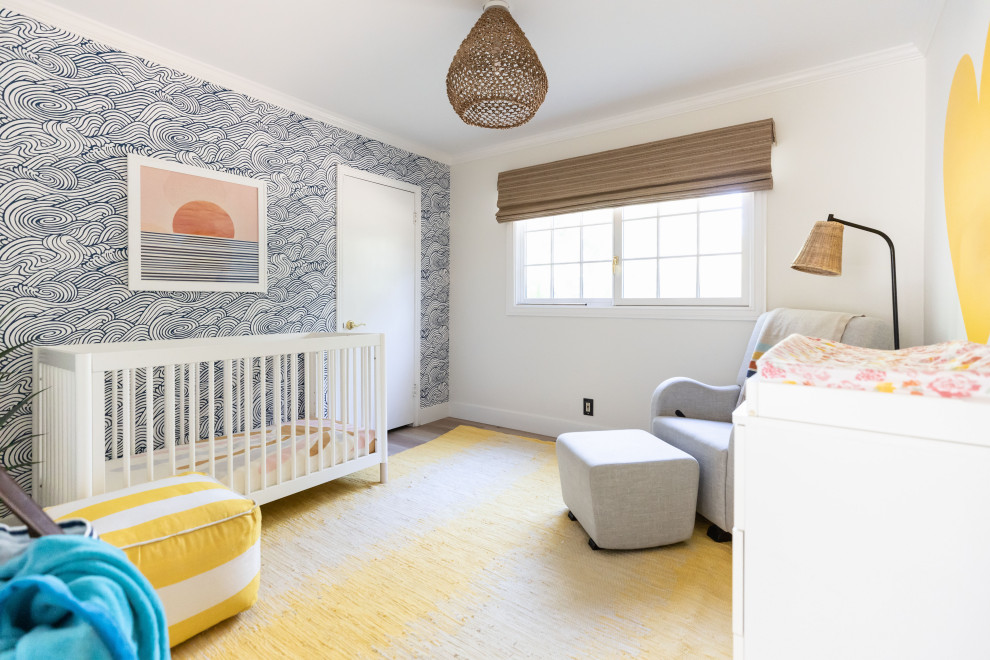 Small coastal gender neutral nursery in San Francisco with yellow walls and wallpapered walls.