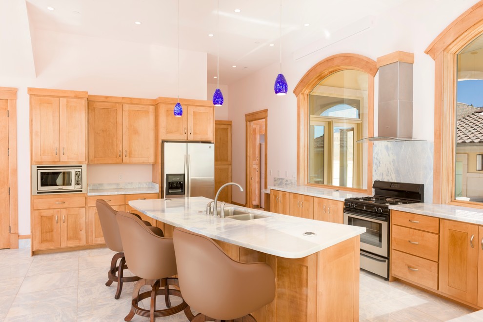 Mid-sized arts and crafts u-shaped kitchen pantry in Salt Lake City with an undermount sink, recessed-panel cabinets, medium wood cabinets, granite benchtops, multi-coloured splashback, stone slab splashback, stainless steel appliances, marble floors and with island.