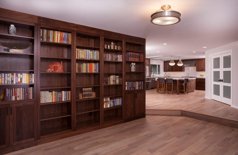 Example of a large transitional u-shaped light wood floor and brown floor eat-in kitchen design in Seattle with a farmhouse sink, dark wood cabinets, white backsplash, subway tile backsplash, stainless steel appliances, an island and white countertops