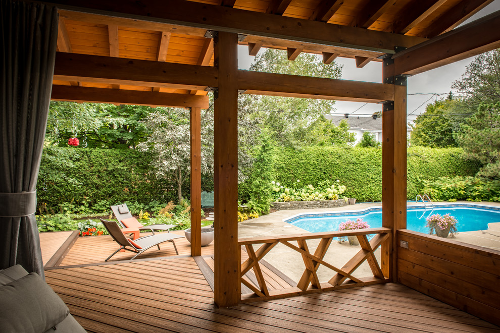 Inspiration for a contemporary backyard patio in Montreal with decking.