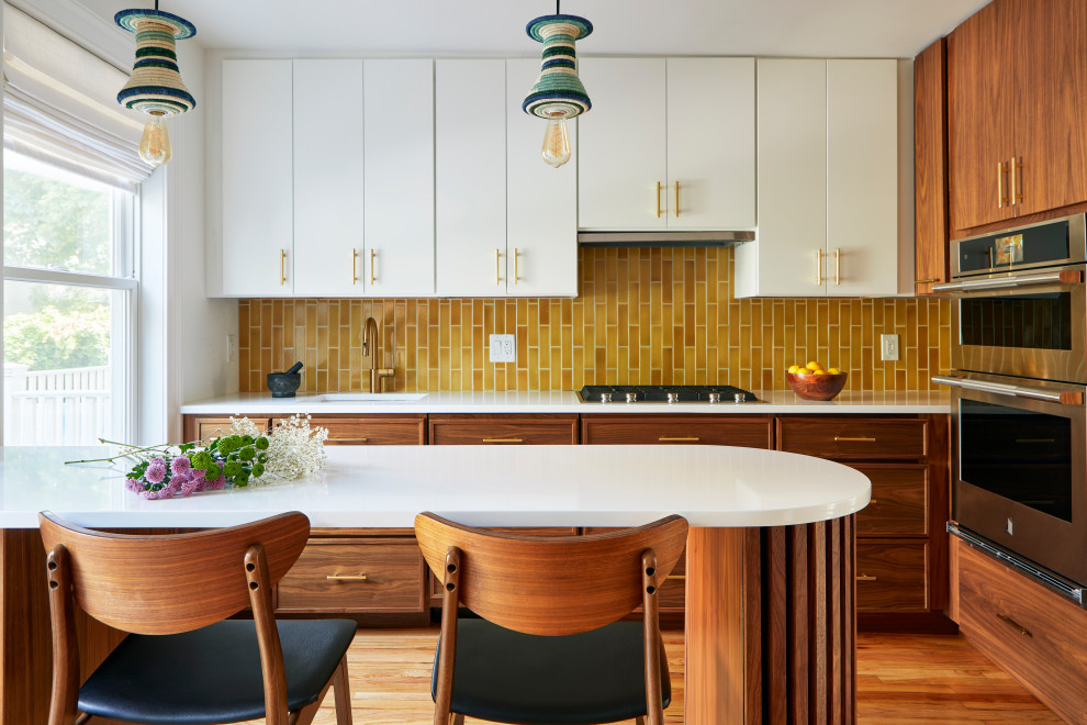 Eat-in kitchen - small 1950s l-shaped brown floor eat-in kitchen idea in Other with an undermount sink, flat-panel cabinets, medium tone wood cabinets, yellow backsplash, an island and white countertops