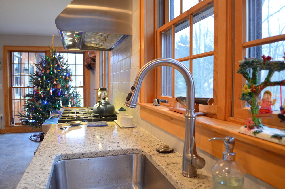 Inspiration for a transitional ceramic tile kitchen remodel with an undermount sink, flat-panel cabinets, gray cabinets, quartz countertops, gray backsplash, ceramic backsplash, stainless steel appliances and an island