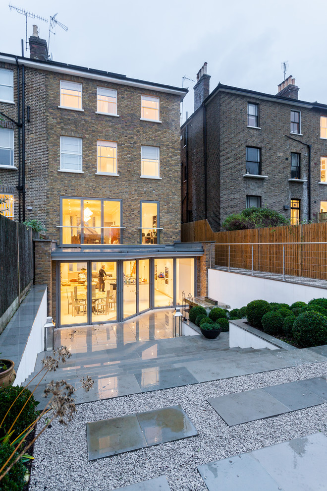 Photo of a mid-sized transitional three-storey brick exterior in London.