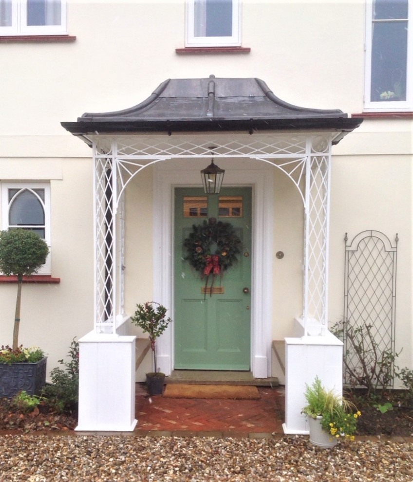 Entryway - mid-sized traditional entryway idea in Other with a green front door