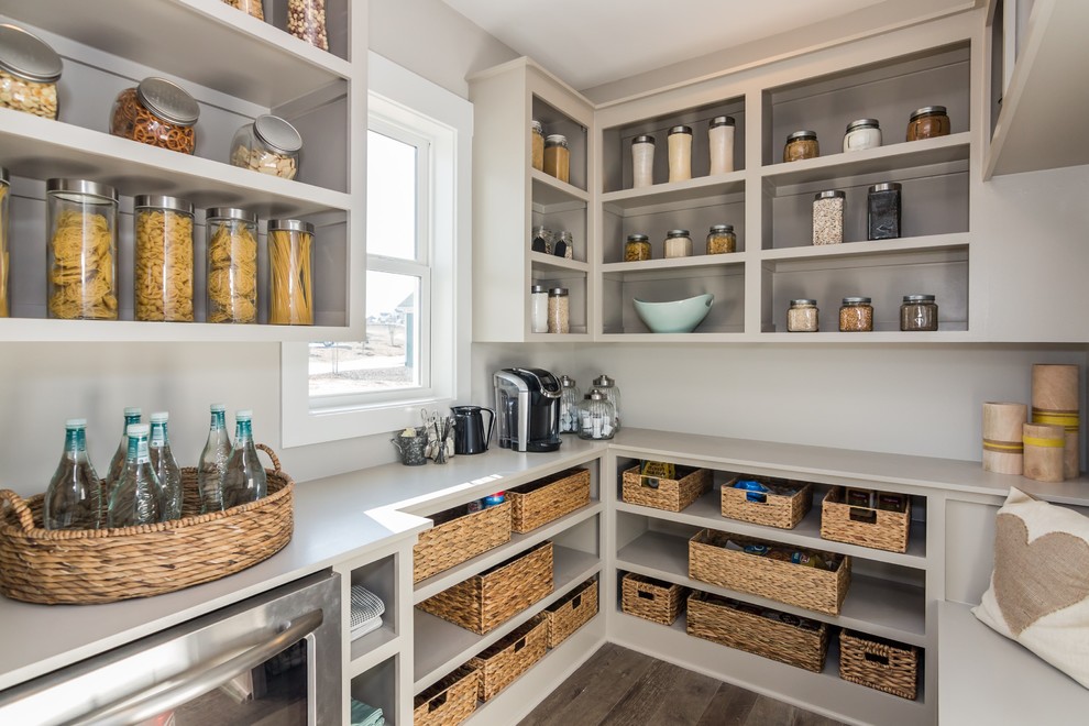 Design ideas for a transitional kitchen pantry in Raleigh with open cabinets, grey cabinets, stainless steel appliances and dark hardwood floors.